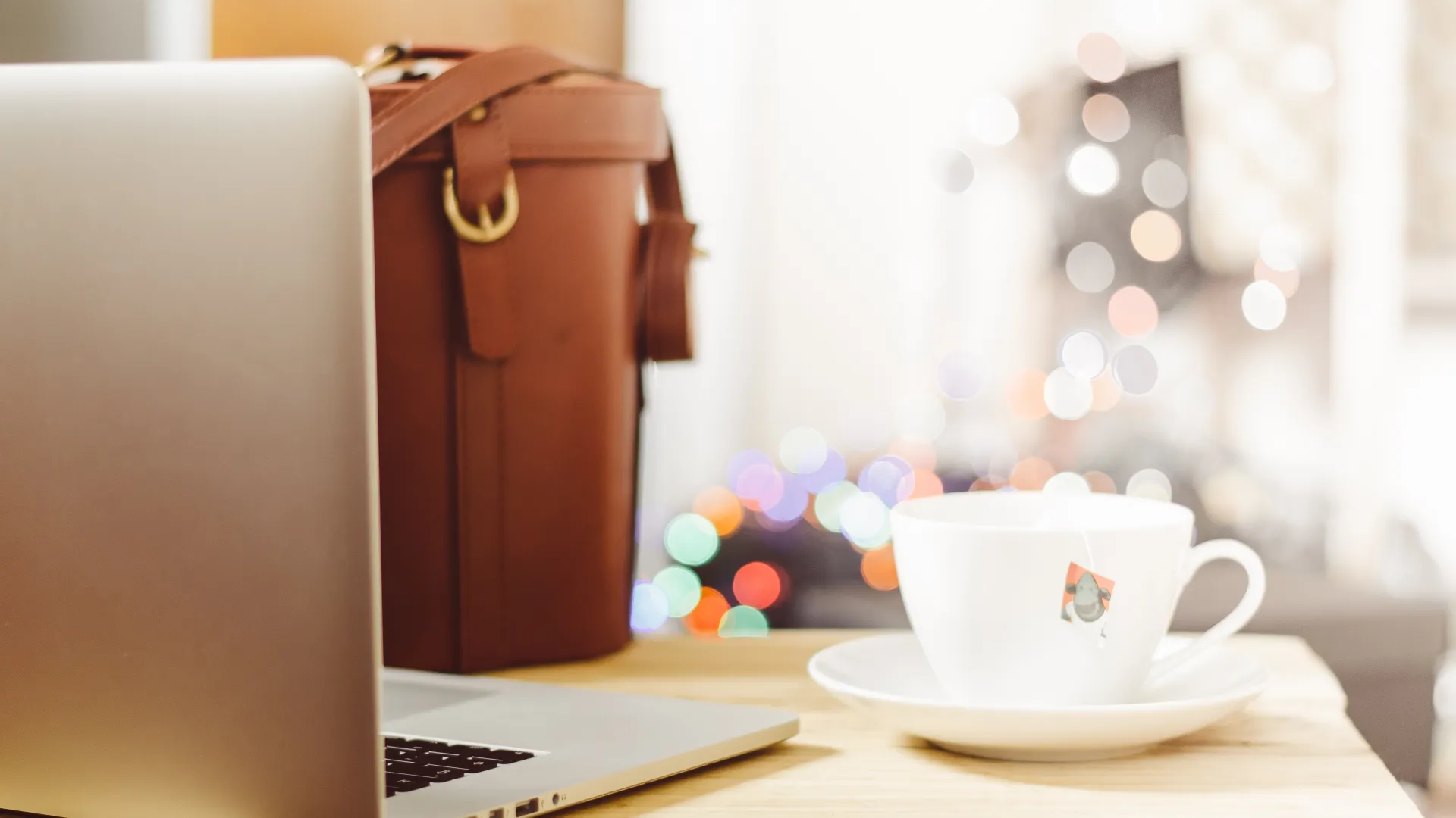 Notebook, bag and cup on a desk